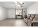 Inviting living room with tile floors, ceiling fan, comfortable sofa, and lots of natural light at 2277 S Apache Dr # 7, Apache Junction, AZ 85120