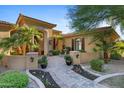 Beautiful home showcasing a decorative entrance, fountain, and lush landscaping at 2799 E Jade Pl, Chandler, AZ 85286