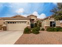 Beautiful home boasting a well-manicured lawn, an attached two-car garage, and a welcoming entryway at 3020 E Tiffany Way, Gilbert, AZ 85298