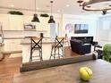 Open kitchen and living area featuring an island with bar stools, and stainless steel appliances at 357 E Las Puertas Ln, Queen Creek, AZ 85140
