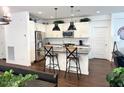 Bright kitchen features an island with bar seating, stainless steel appliances, and white cabinets at 357 E Las Puertas Ln, Queen Creek, AZ 85140