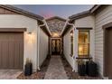 Inviting entryway featuring brick pavers, a charming front door, and lovely plants at 4247 E Tonto Pl, Chandler, AZ 85249
