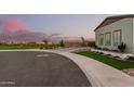 Exterior shot of the grassy lawn and xeriscaping surrounding this home at 4247 E Tonto Pl, Chandler, AZ 85249