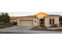 Inviting single-story home featuring desert landscaping, two-car garage, and neutral paint at 5405 S Marigold Way, Gilbert, AZ 85298