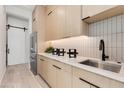 Modern butlers pantry features custom cabinets and stainless refrigerator at 6149 E Voltaire Ave, Scottsdale, AZ 85254