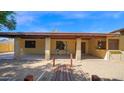 Inviting covered back patio with brick columns, overlooking a gravel yard at 6713 N 80Th Pl, Scottsdale, AZ 85250