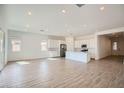 Bright and open floor plan with white walls, recessed lighting, and wood-look tile throughout at 855 W Peralta Pass, Apache Junction, AZ 85120