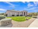Well-maintained front yard featuring lush green grass and desert landscaping with bright blue skies at 9167 E Tarantini Ln, Scottsdale, AZ 85260