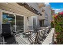 Cozy patio with string lights, patio furniture, and colorful blooming bushes create a peaceful outdoor space at 985 N Granite Reef Rd # 127, Scottsdale, AZ 85257