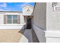 Inviting entryway with a decorative security door, shutters, and desert landscaping for low maintenance at 10320 E Lupine Ln, Florence, AZ 85132