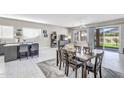 Open-concept living space with dining area, kitchen island and natural light from the sliding glass doors at 108 N Pioneer St, Gilbert, AZ 85233