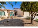 Beautiful home with low maintenance landscaping and a welcoming covered front porch, complemented by an attached two-car garage at 10960 E Monte Ave # 242, Mesa, AZ 85209