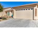 Inviting home with well-maintained xeriscaping, front porch seating, and an attached two-car garage featuring arched window panes at 10960 E Monte Ave # 242, Mesa, AZ 85209