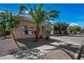 Charming home featuring desert landscaping in the front yard with sidewalk access at 13569 W Ventura St, Surprise, AZ 85379