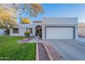 Charming single-story home with a well-maintained lawn and a two-car garage at 1601 E Elgin St, Chandler, AZ 85225