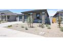 Beautiful single-story home with a stone-accented porch and drought-tolerant landscaping at 17996 W Camino De Oro --, Surprise, AZ 85387