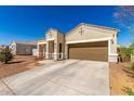 Well-maintained one-story home featuring a two-car garage and desert landscaping at 18800 W Madison St, Buckeye, AZ 85326