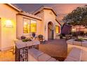 Cozy front patio featuring desert landscaping, a seating area, and a charming entryway at 20151 N Riverbank Rd, Maricopa, AZ 85138