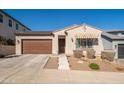 Inviting home with a brown garage door and a charming awning over the front window, creating a warm and welcoming entrance at 21150 W Minnezona Ave, Buckeye, AZ 85396