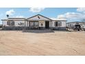 One-story house with front porch and dirt yard at 21621 W Narramore Rd, Buckeye, AZ 85326