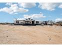 Single-story home with a covered porch and a horse decoration on the front; cars parked outside at 21621 W Narramore Rd, Buckeye, AZ 85326