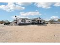 Exterior shot of a one-story white home with front porch at 21621 W Narramore Rd, Buckeye, AZ 85326