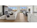 Bright living room featuring a linear fireplace, hardwood floors and expansive windows with cityscape views at 2211 E Camelback Rd # 601, Phoenix, AZ 85016