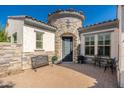 Inviting front entrance with stone accents, a wrought iron door, and a cozy seating area at 22426 N 29Th Pl, Phoenix, AZ 85050