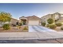 Single-story home with low maintenance desert landscaping and a paved driveway at 30945 W Picadilly Rd, Buckeye, AZ 85396