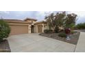 Stylish home with a three-car garage and desert landscaping for curb appeal at 31483 N 133Rd Dr, Peoria, AZ 85383