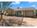 Inviting single-story home featuring desert landscaping, a front patio, and an attached garage at 3342 N 63Rd Ave, Phoenix, AZ 85033