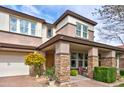 Inviting two-story home featuring a well-maintained lawn, brick driveway, a covered porch and lovely landscaping at 3744 E Sierra Madre Ave, Gilbert, AZ 85296