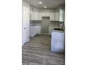 Bright updated kitchen featuring white cabinets and a sleek marble-look island at 4038 E Burgess Ln, Phoenix, AZ 85042