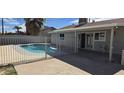 Backyard view of sparkling pool and covered patio, perfect for outdoor relaxation at 4038 E Burgess Ln, Phoenix, AZ 85042