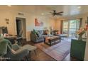 Comfortable living room featuring hardwood floors, a ceiling fan, and a sliding glass door at 4120 N 78Th St # 217, Scottsdale, AZ 85251