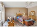 Bedroom with a wooden bed frame, hard floors, and a bright window at 43228 N 14Th St, New River, AZ 85087