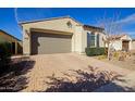 Single-story home with a brick-paved driveway, two-car garage, and well-maintained desert landscaping at 5844 S Tobin --, Mesa, AZ 85212