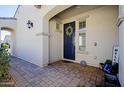 Inviting entryway featuring a navy blue front door adorned with a wreath, set in a neutral-toned facade at 5844 S Tobin --, Mesa, AZ 85212