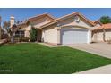 Lovely home featuring a lush green lawn and a pristine white garage door at 6834 S Dennis Dr, Tempe, AZ 85283