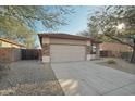 Charming home featuring a three-car garage and a well-maintained driveway at 7355 W Red Hawk Dr, Peoria, AZ 85383