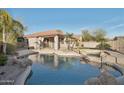 A captivating backyard pool area offering a serene escape in a lush, private setting at 7355 W Red Hawk Dr, Peoria, AZ 85383