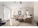 Bright living room with high vaulted ceiling, modern flooring, large sectional sofa, and natural light at 8029 W Whyman Ave, Phoenix, AZ 85043