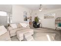 Inviting living room featuring vaulted ceiling, modern flooring, and comfortable seating area at 8029 W Whyman Ave, Phoenix, AZ 85043