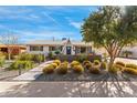 Charming single-story home with a well-manicured front yard and desert landscaping at 8443 E Sheridan St, Scottsdale, AZ 85257