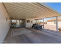 Spacious covered carport with golf cart, extra storage and access to the home at 8500 E Southern Ave # 551, Mesa, AZ 85209