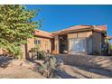 Inviting single-story home with gated front patio and desert landscaping with a tiled roof at 9130 E Crystal Dr, Sun Lakes, AZ 85248