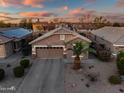 Aerial view of a desert home displaying the roof, driveway, and surrounding community at 1013 S Hazel Ct, Gilbert, AZ 85296