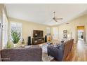 Bright living room with wood flooring, large windows, and comfortable seating arrangement at 1013 S Hazel Ct, Gilbert, AZ 85296