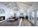 Bright and airy living room with vaulted ceilings, a fireplace, and hardwood floors at 10440 E Larkspur Dr, Scottsdale, AZ 85259