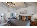 Serene main bedroom with a sitting area, chandelier, and ample natural light at 10440 E Larkspur Dr, Scottsdale, AZ 85259